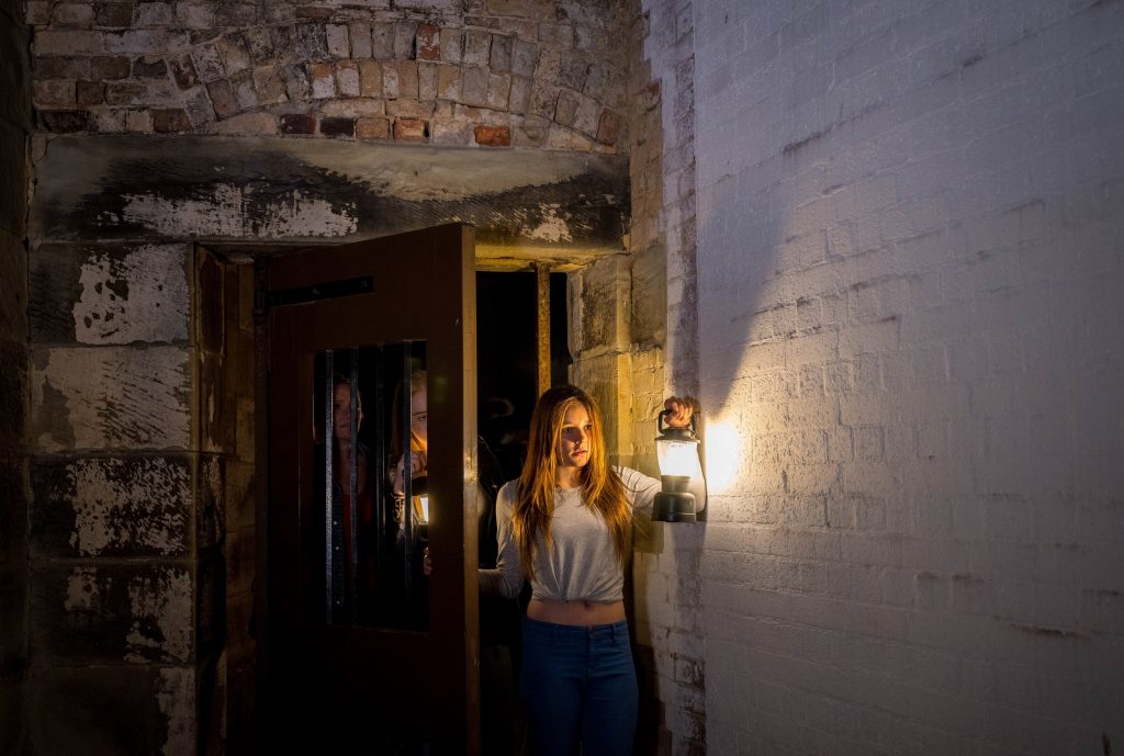 guests carrying lanterns on the ghost tour